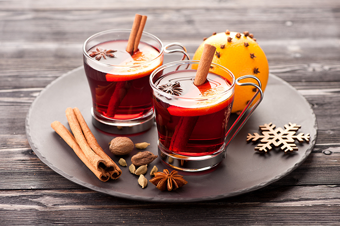 Christmas mulled wine with spices on wooden background
